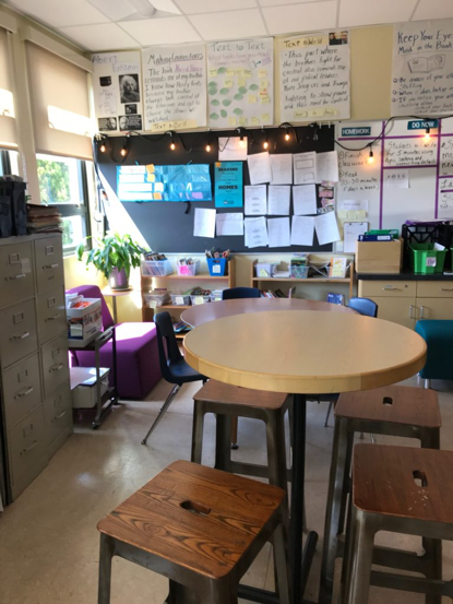View of a classroom. Tall desk, short desk, sofa