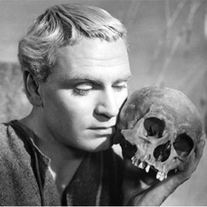 black and white photo of Hamlet holding a skull to his cheek