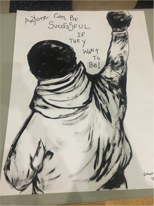 PBL project display: drawing of a youth with their fist raised up "Anyone can be successful if they want to be"